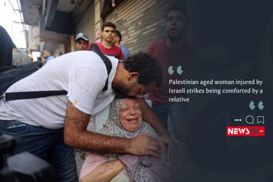 Palestinian aged woman injured by Israeli strikes being comforted by a relative